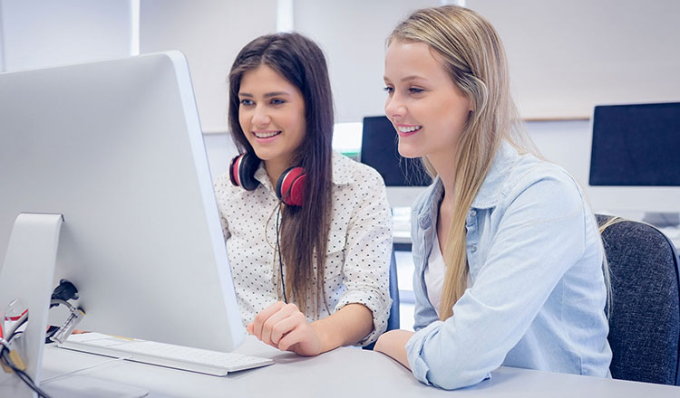 Spanish students working on language skills with computer