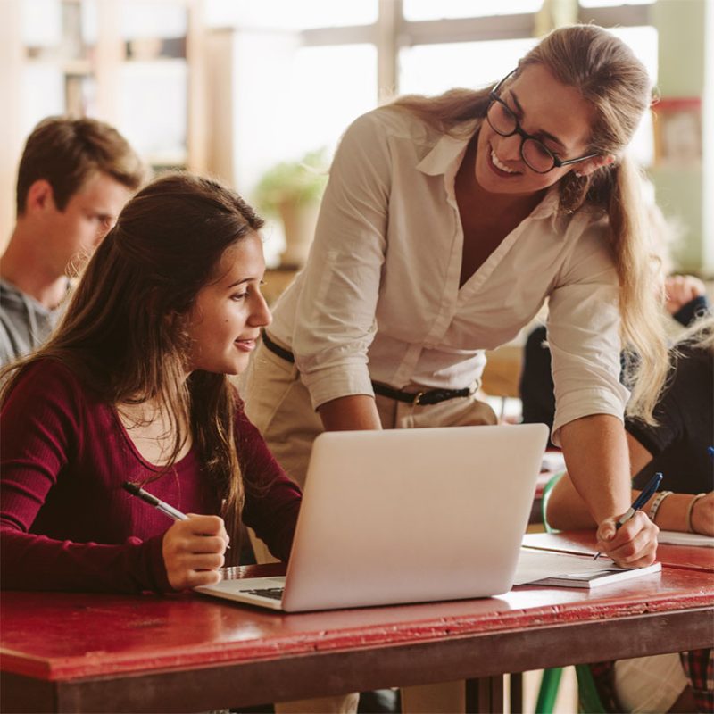 Students learning Spanish with native teacher in class